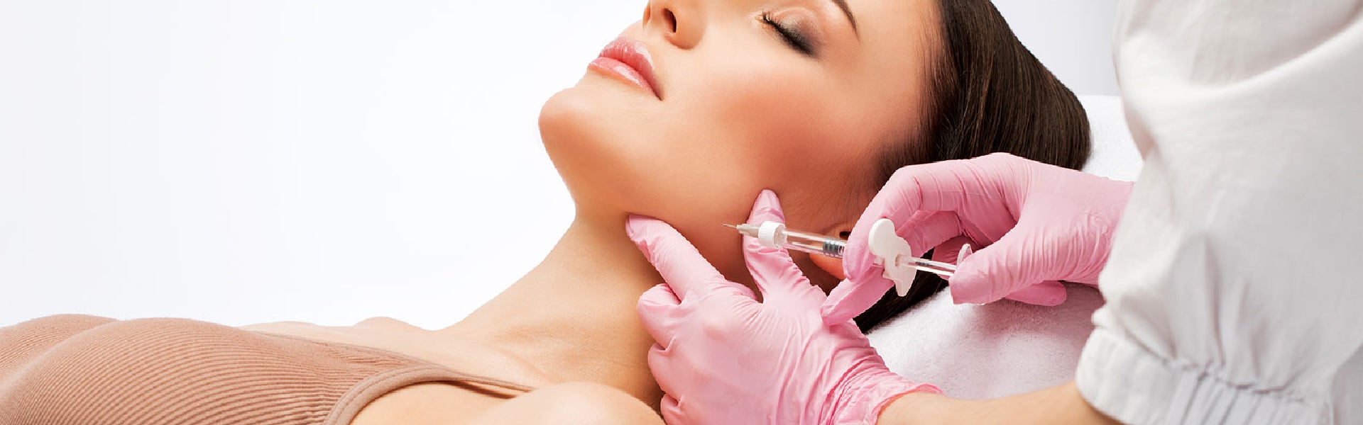 Medical professional administering an injectable cosmetic treatment to the neck area during a non-surgical aesthetic procedure.